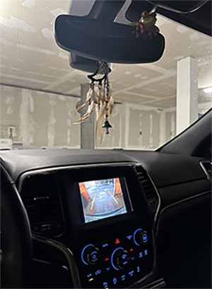 Picture of a carplay screen with the reverse camera displaying the exit to my garage